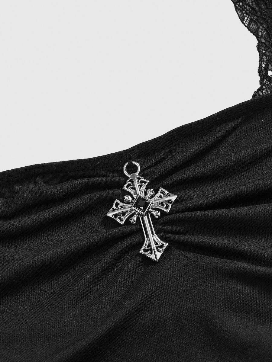Front view of a women's black gothic Y2K halter crop top with contrast lace trim, ruched waist detail, cross accent, and tie-back backless design.