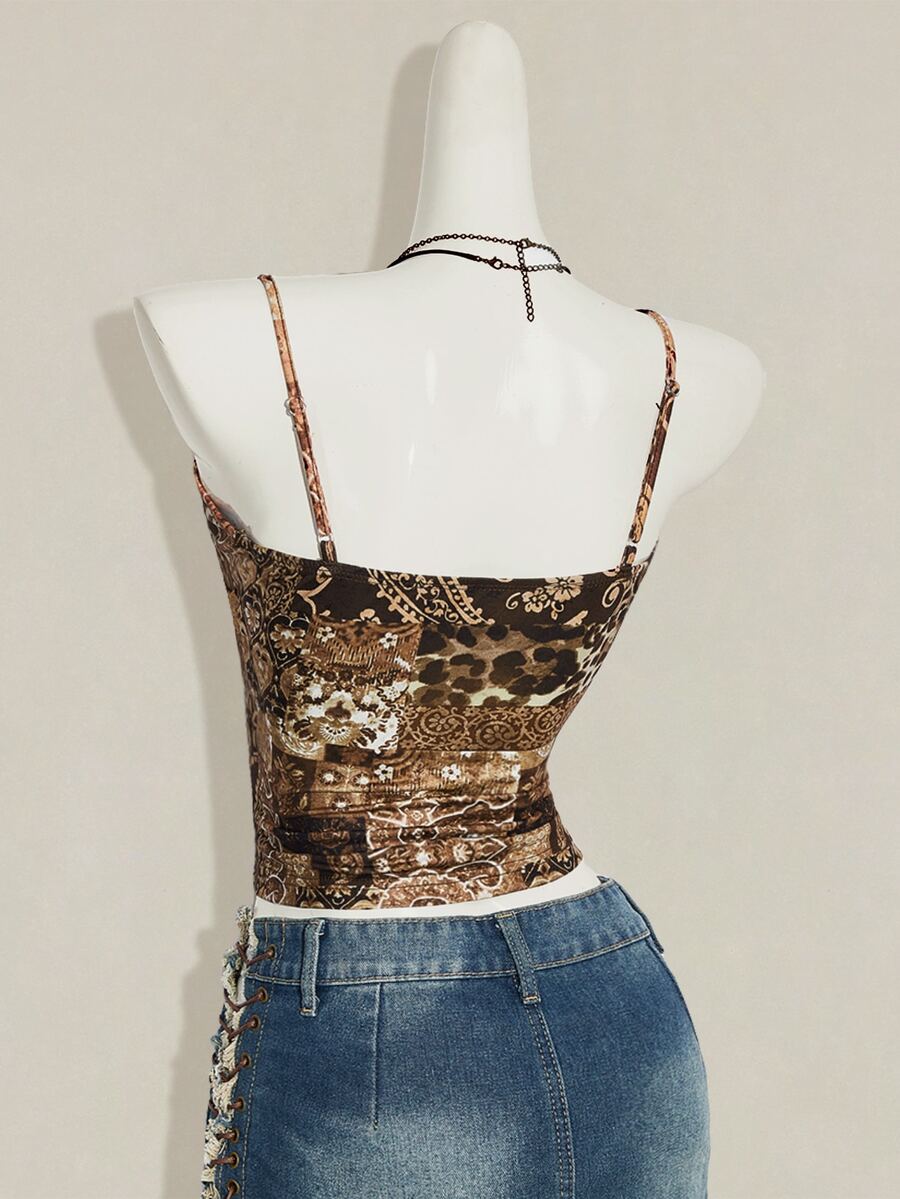 Women's blue fitted camisole top with contrast lace patchwork print, backless asymmetrical hem, and spaghetti straps.