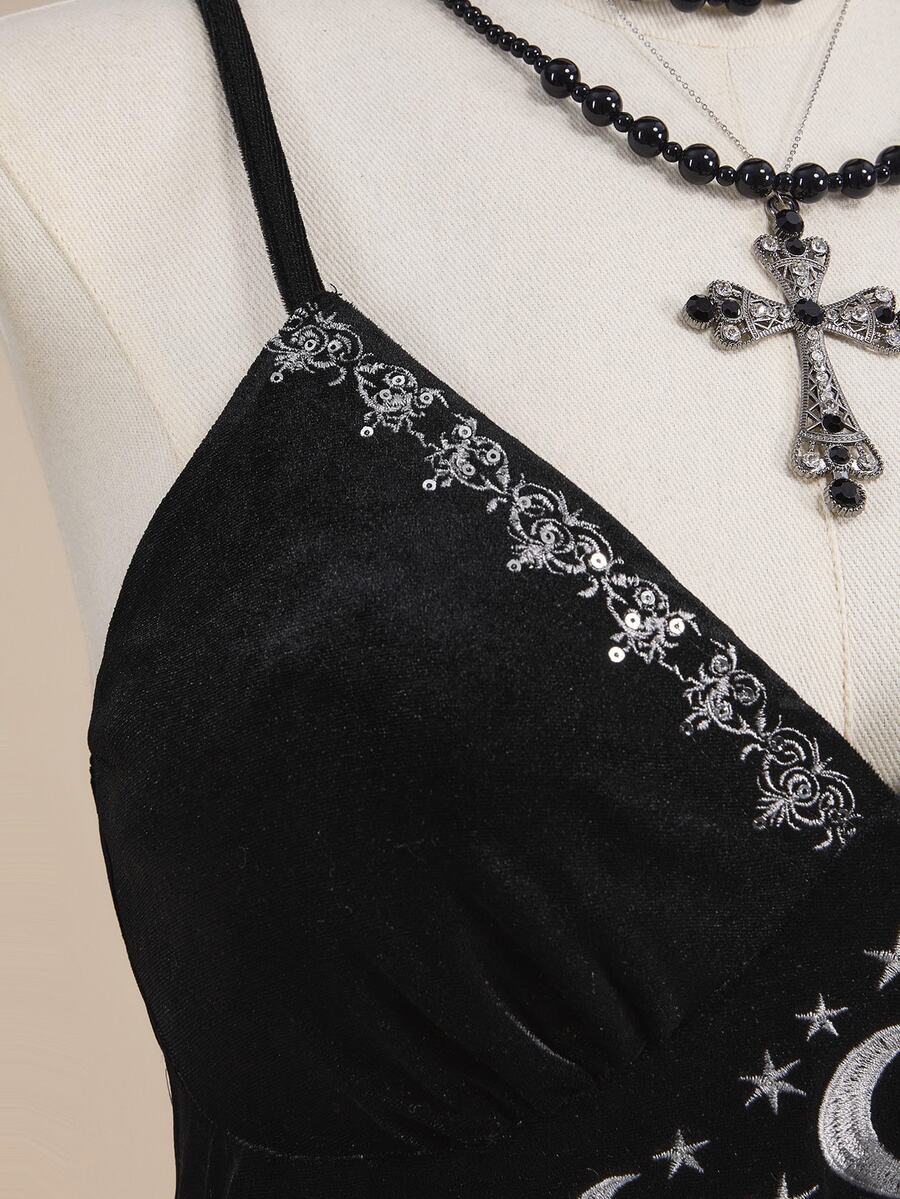 Black velvet camisole top featuring an astrology moon and star graphic print, spaghetti straps, and a backless lace-up design.