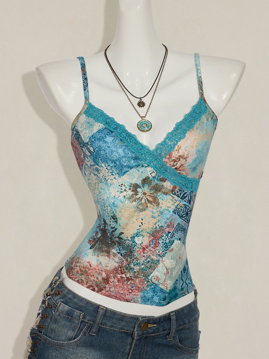 Women's blue fitted camisole top with contrast lace patchwork print, backless asymmetrical hem, and spaghetti straps.