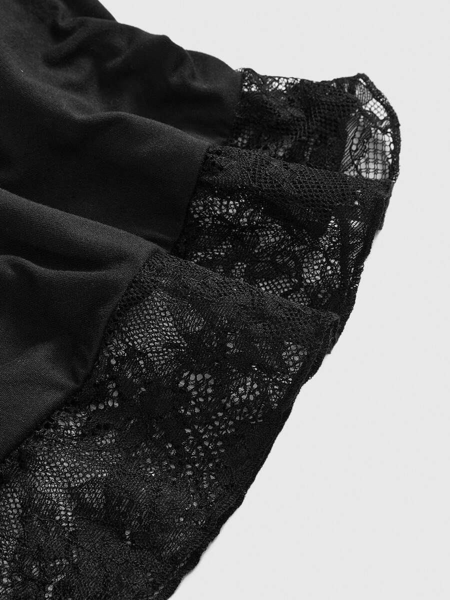 Front view of a women's black gothic Y2K halter crop top with contrast lace trim, ruched waist detail, cross accent, and tie-back backless design.