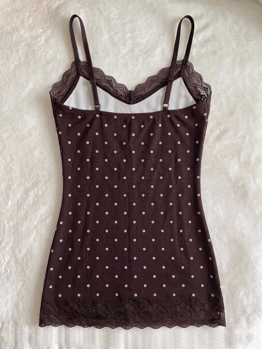 Women's solid color slim fit camisole top featuring delicate lace patchwork embroidery and tank straps.