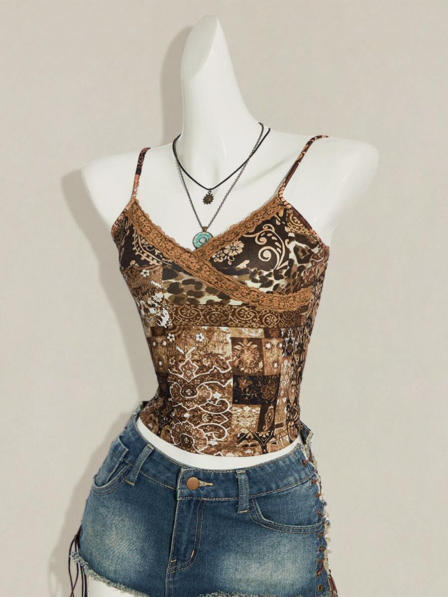 Women's blue fitted camisole top with contrast lace patchwork print, backless asymmetrical hem, and spaghetti straps.