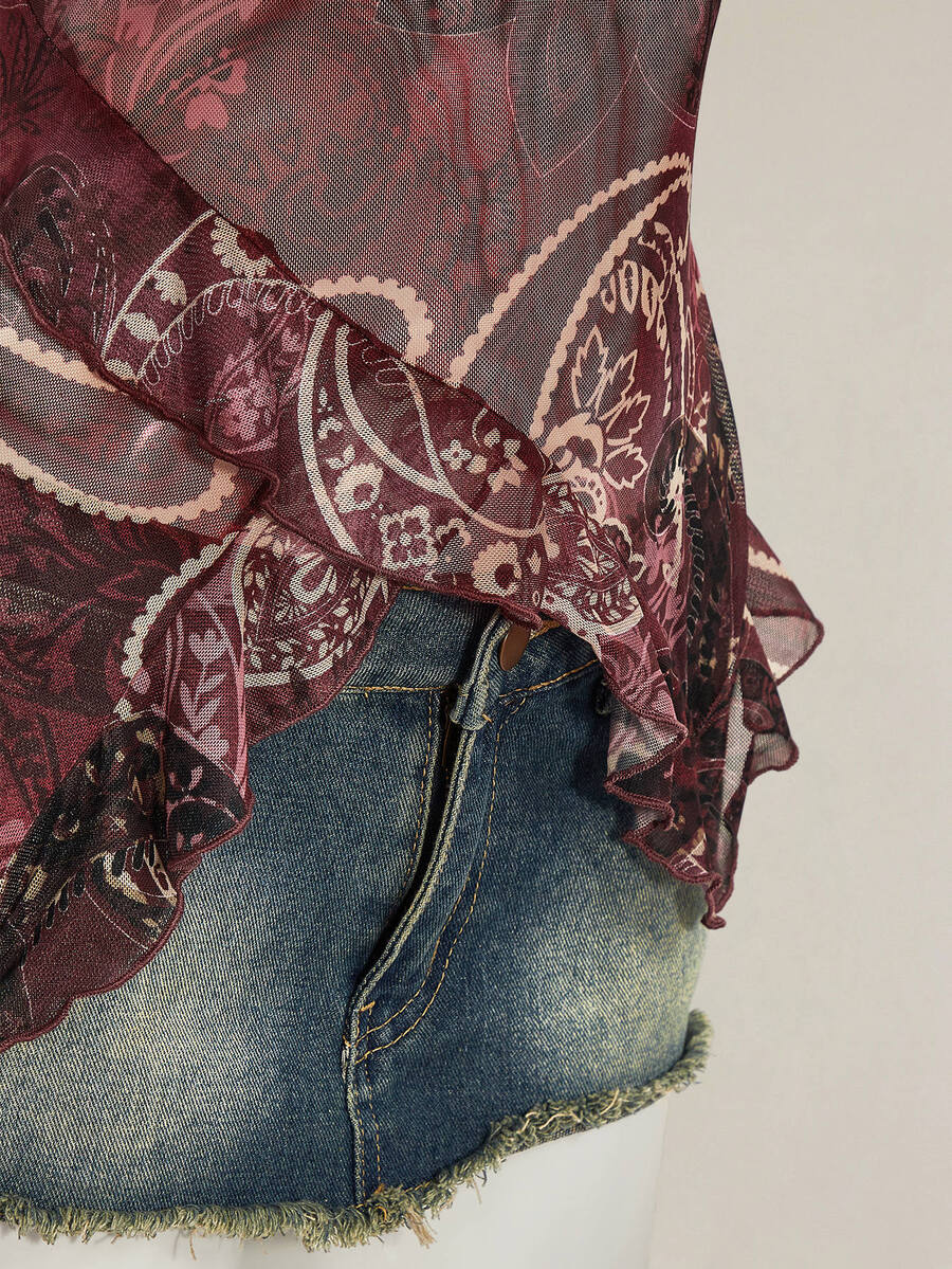Women's burgundy floral graphic print mesh camisole top featuring an asymmetrical hem, backless cut, and spaghetti straps.