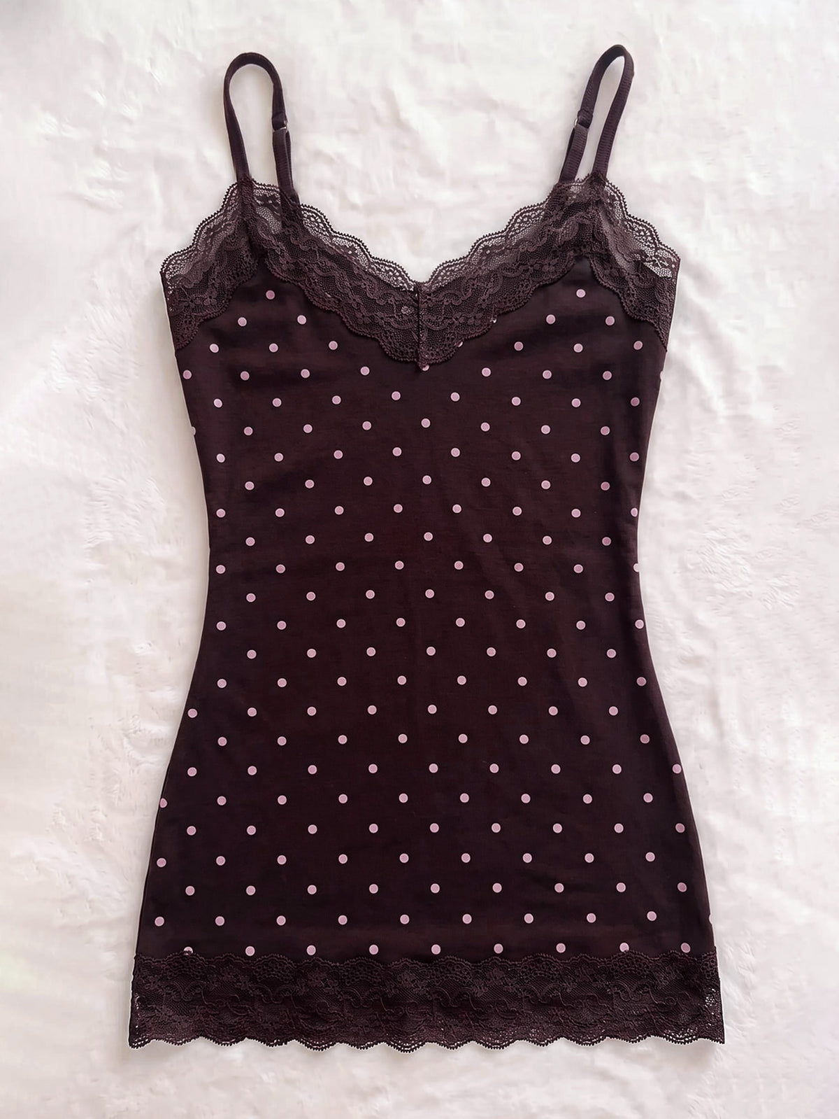 Women's solid color slim fit camisole top featuring delicate lace patchwork embroidery and tank straps.