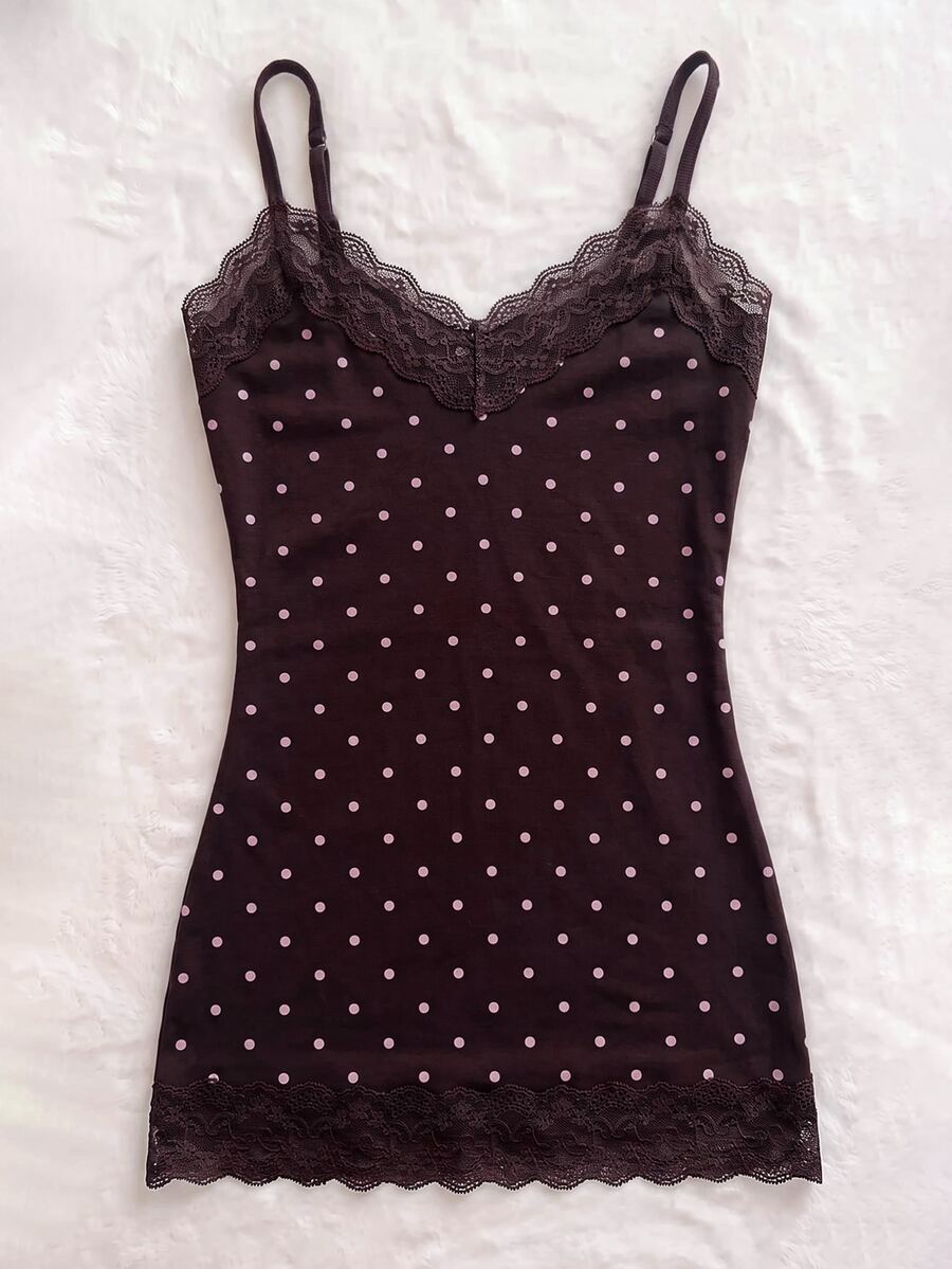 Women's solid color slim fit camisole top featuring delicate lace patchwork embroidery and tank straps.