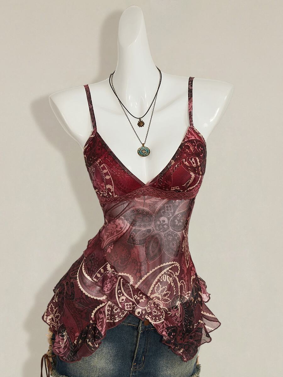 Women's burgundy floral graphic print mesh camisole top featuring an asymmetrical hem, backless cut, and spaghetti straps.