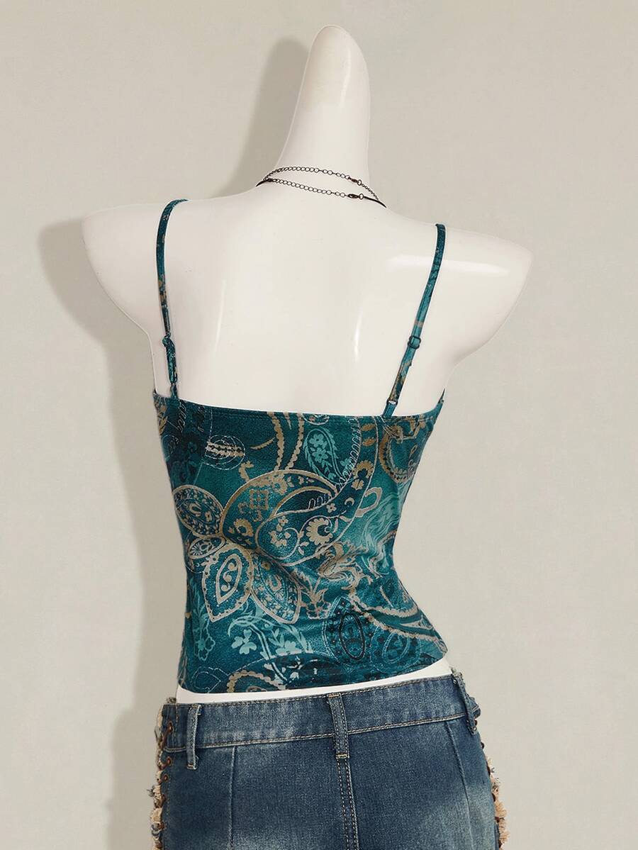 Women's blue fitted camisole top with contrast lace patchwork print, backless asymmetrical hem, and spaghetti straps.