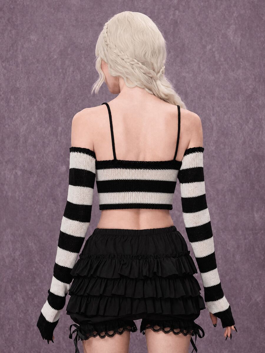 Women wearing a black and white striped camisole knit crop top with spaghetti straps and extra-long cold shoulder sleeves.