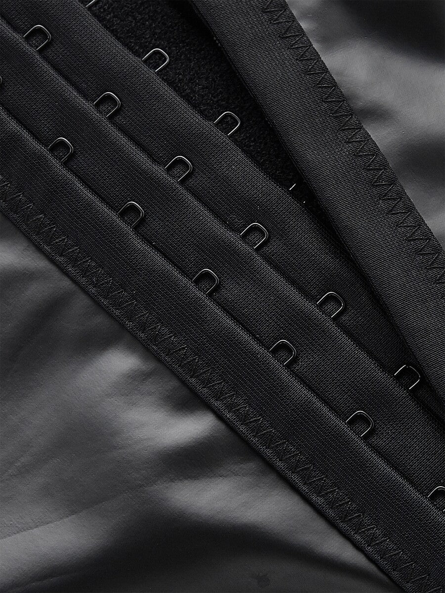 A women's black velvet crop camisole top featuring criss-cross shoulder straps, asymmetrical cut-out details, and a sleeveless vest neckline.