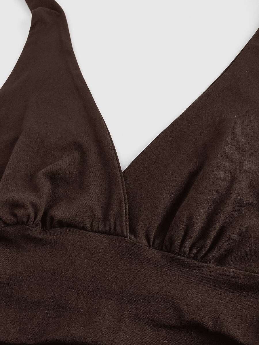 Women's halter crop tank top featuring a backless silhouette and ruched detailing in a slim fit design.