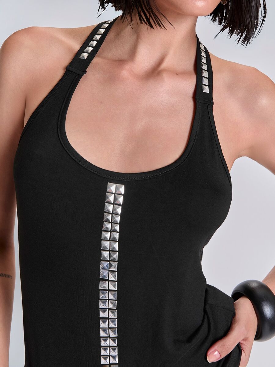 Black backless halter crop tank top with metal rivet trim detail and slim fit.