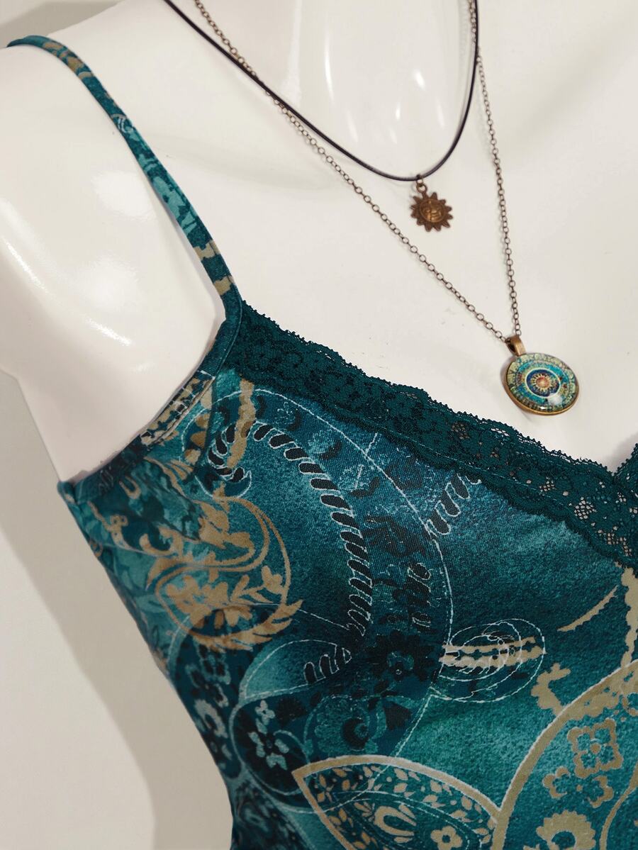 Women's blue fitted camisole top with contrast lace patchwork print, backless asymmetrical hem, and spaghetti straps.