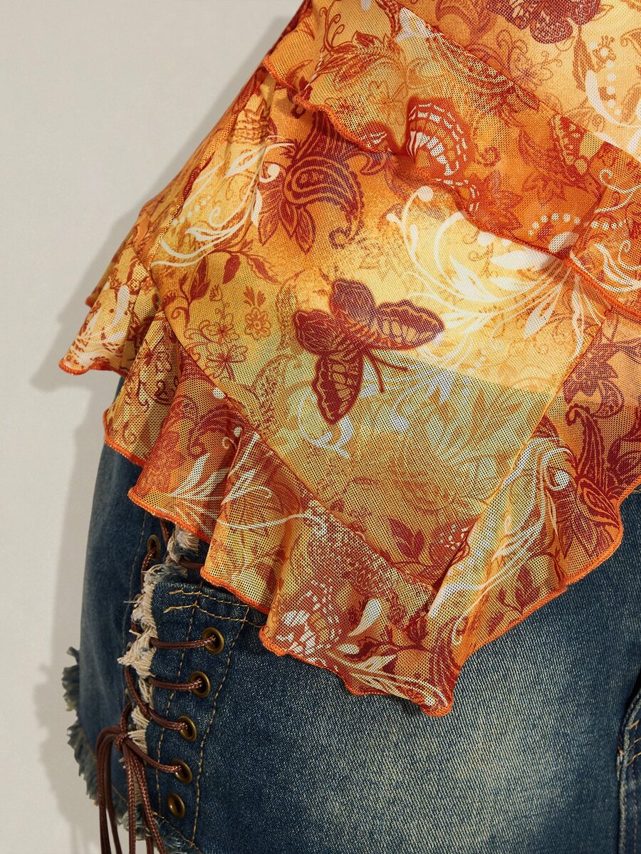Women's burgundy floral graphic print mesh camisole top featuring an asymmetrical hem, backless cut, and spaghetti straps.