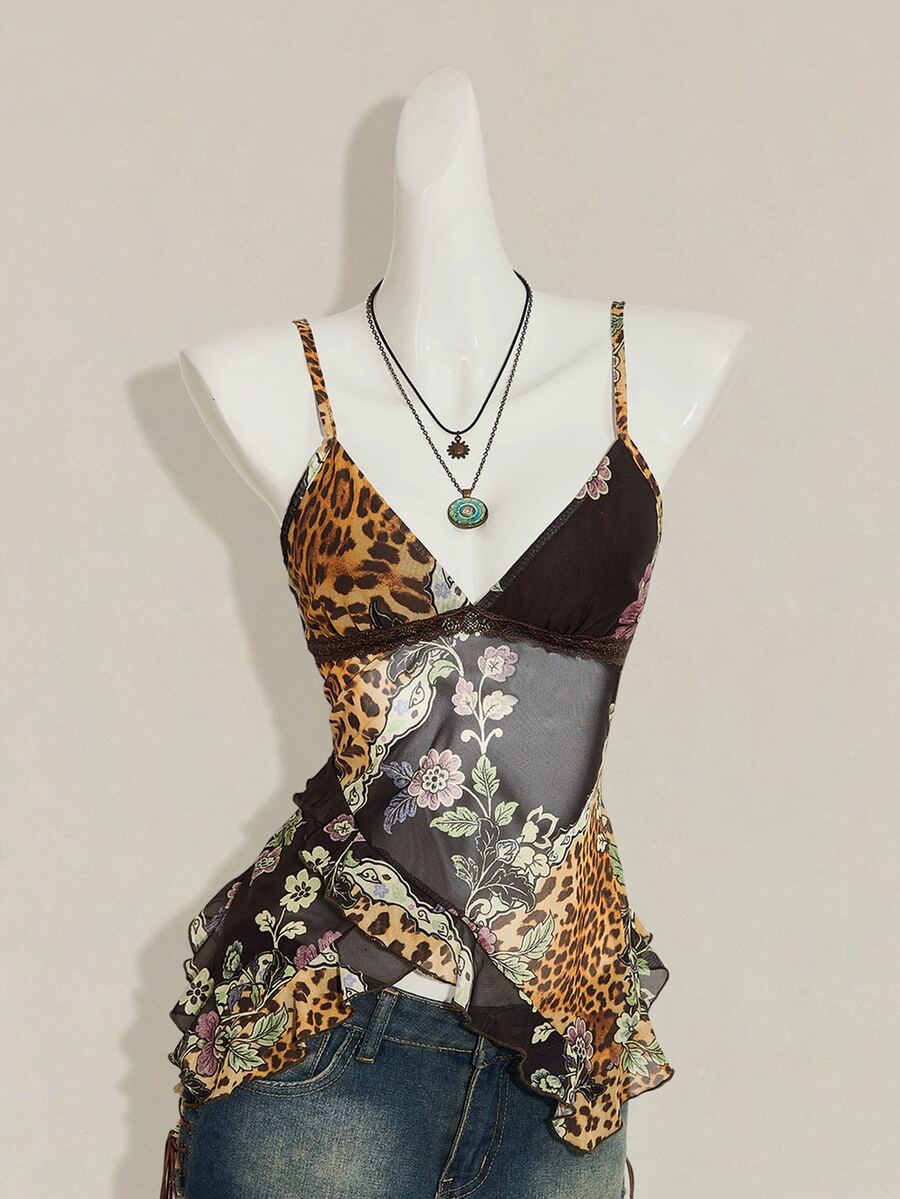 Women's burgundy floral graphic print mesh camisole top featuring an asymmetrical hem, backless cut, and spaghetti straps.