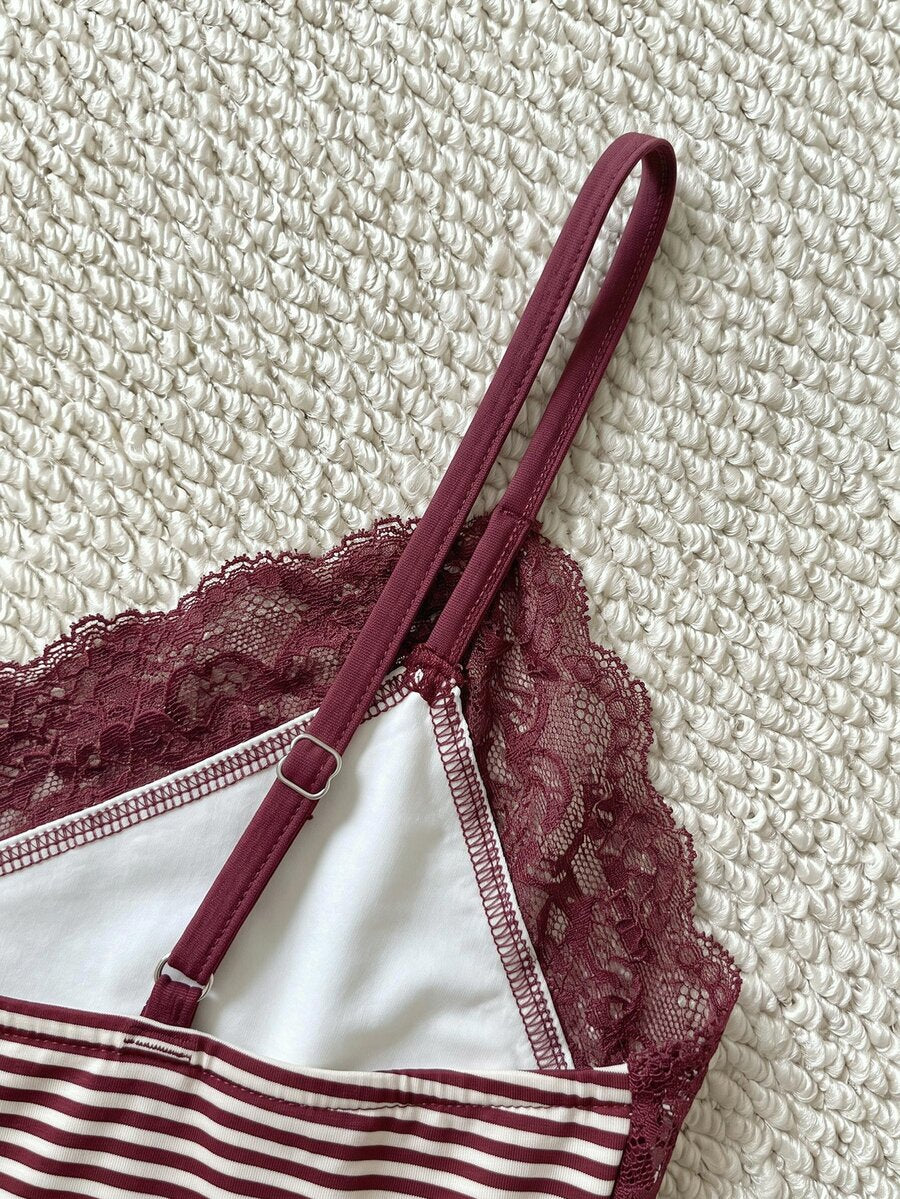 Women's solid color slim fit camisole top featuring delicate lace patchwork embroidery and tank straps.