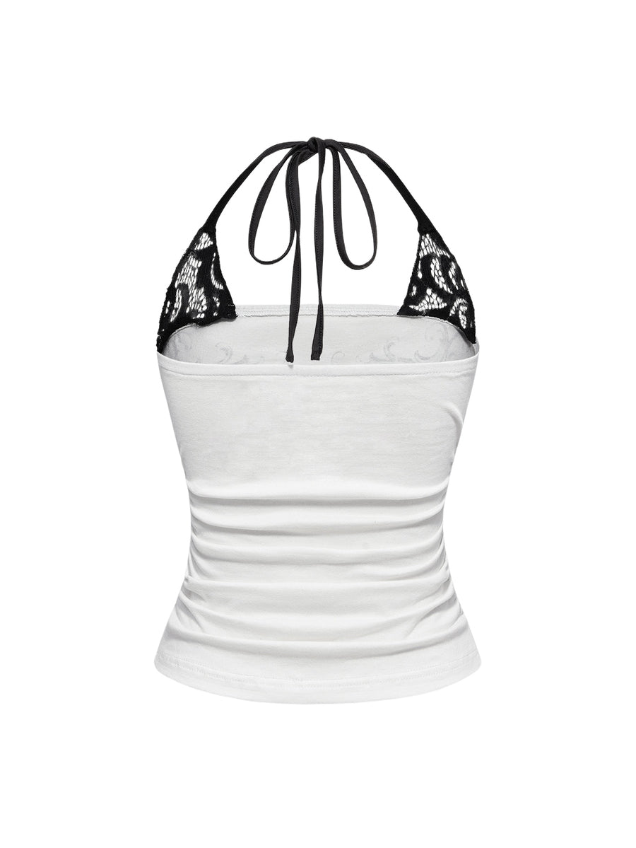Woman wearing a black Y2K concert print 2-in-1 contrast lace halter crop top featuring a backless design with knot details.