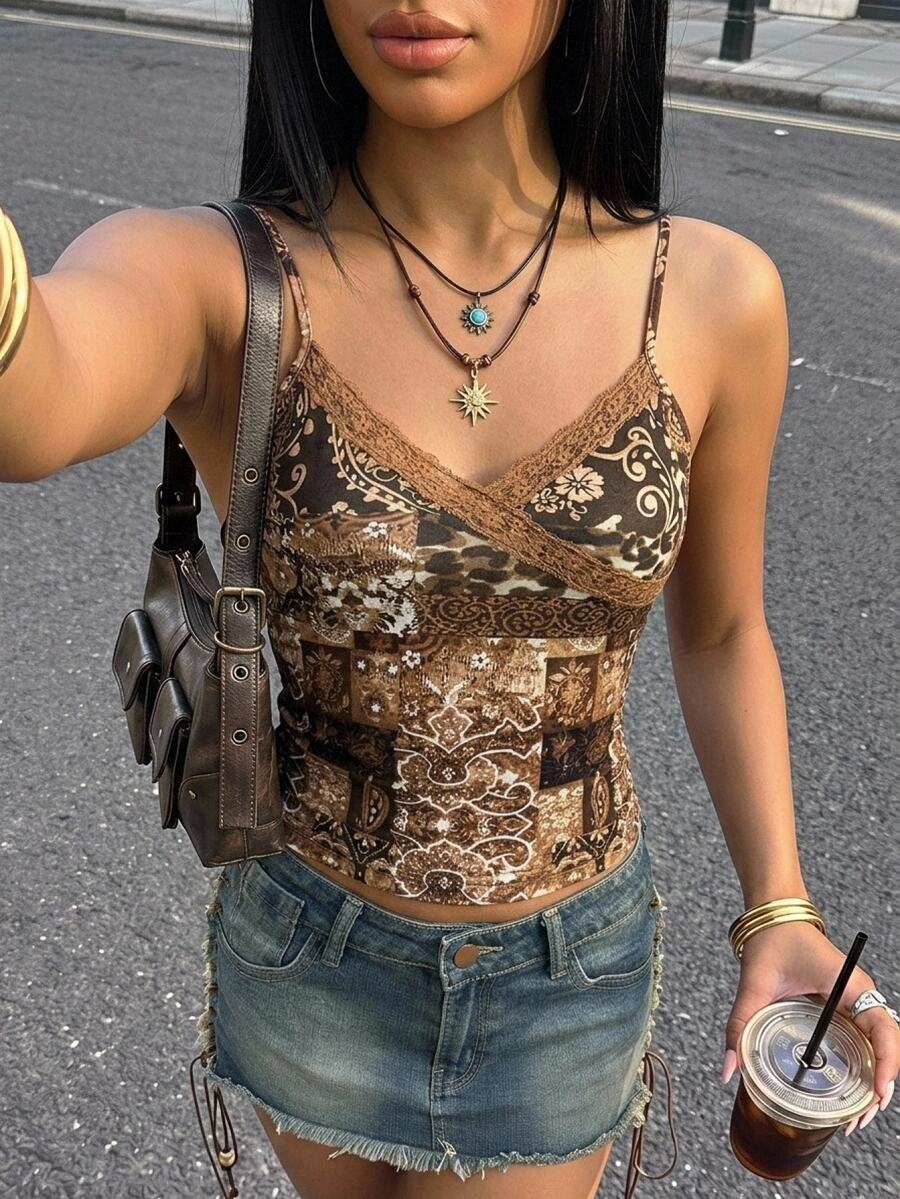 Women's blue fitted camisole top with contrast lace patchwork print, backless asymmetrical hem, and spaghetti straps.