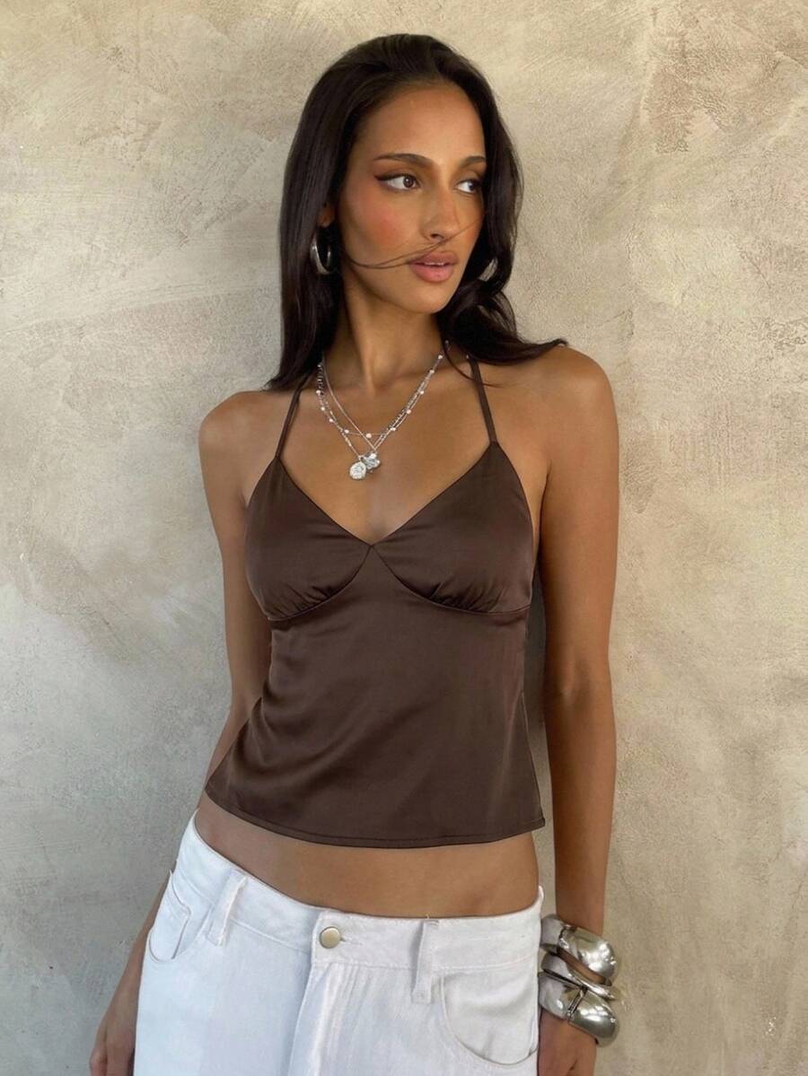 Women's black faux leather backless cami top with spaghetti straps and lace-up shirred sides.