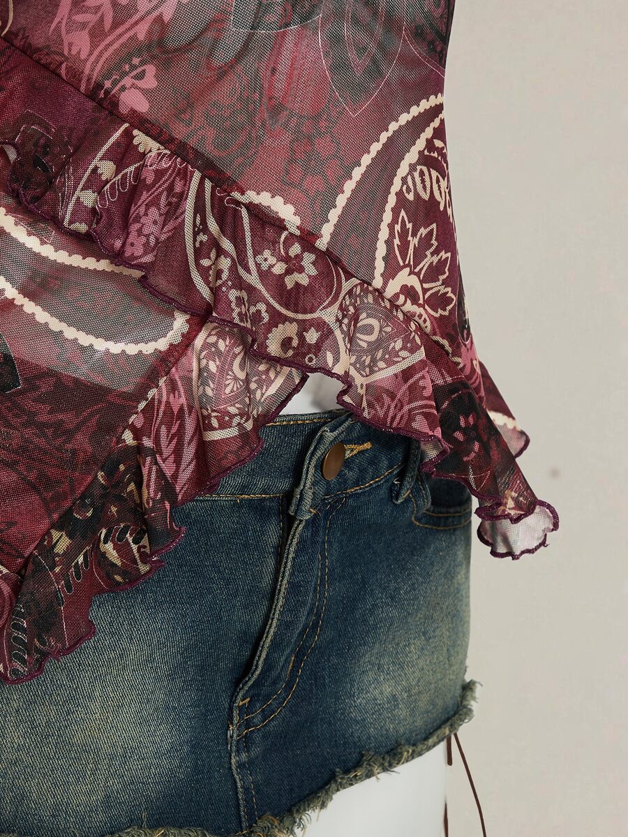 Women's burgundy floral graphic print mesh camisole top featuring an asymmetrical hem, backless cut, and spaghetti straps.